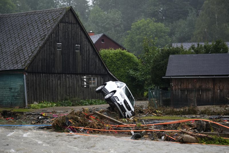 A car is stucked on a river bank after recent floods in Domasov, Czech Republic, Monday, Sept. 16, 2024. (AP Photo/Petr David Josek)