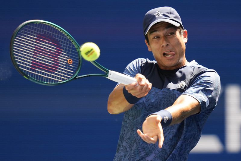 Mackenzie McDonald, of the United States, returns a shot to Jannik Sinner, of Italy, during the first round of the U.S. Open tennis championships, Tuesday, Aug. 27, 2024, in New York. (AP Photo/Kirsty Wigglesworth)