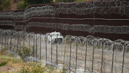 FILE - A vehicle drives along the U.S. side of the US-Mexico border wall in Nogales, Ariz., June 25, 2024. The Biden administration is making asylum restrictions at the southern border even tougher. The changes come in the middle of an election campaign where border security is a key concern for voters, and the administration is increasingly eager to show voters it's taking a hard stance. (AP Photo/Jae C. Hong, Pool, File)