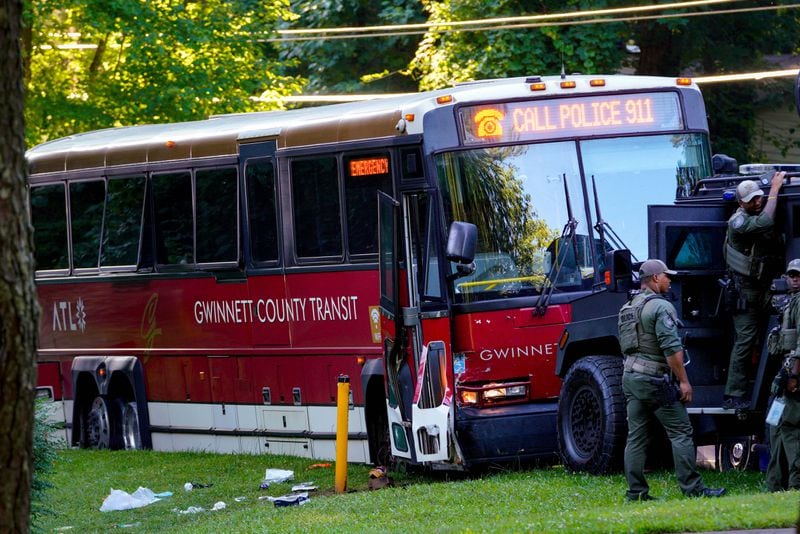 A Dekalb County SWAT vehicle is seen blocking the bus involved in the police chase and hostage situation Tuesday afternoon. July 11, 2024 (Ben Hendren for the Atlanta Journal-Constitution) 