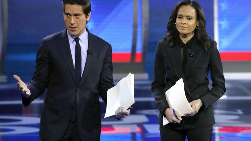 FILE - ABC World News Tonight Anchor David Muir, left, addresses members of the audience while standing with ABC News Live Anchor Linsey Davis, Friday, Feb. 7, 2020 in Manchester, N.H. (AP Photo/Elise Amendola, File)