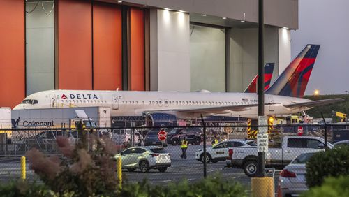 Multiple Atlanta Fire Rescue Department units and police park outside a Delta Maintenance facility near Hartsfield-Jackson International Airport early Tuesday, Aug. 27, 2024 in Atlanta. (John Spink/Atlanta Journal-Constitution via AP)