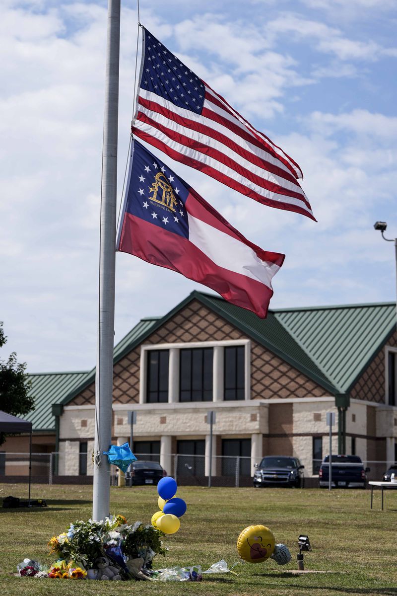 The American and state of Georgia flags fly half-staff after a shooting Wednesday at Apalachee High School, Thursday, Sept. 5, 2024, in Winder, Ga. (AP Photo/Mike Stewart)