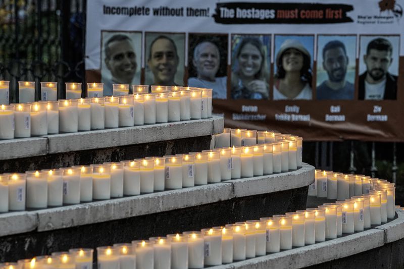 People light 1200 candles in front of the synagogue in Duesseldorf, Germany, Monday, Oct. 7, 2024, marking the first anniversary of the Oct. 7, 2023 attacks on Israel. (AP Photo/Martin Meissner)