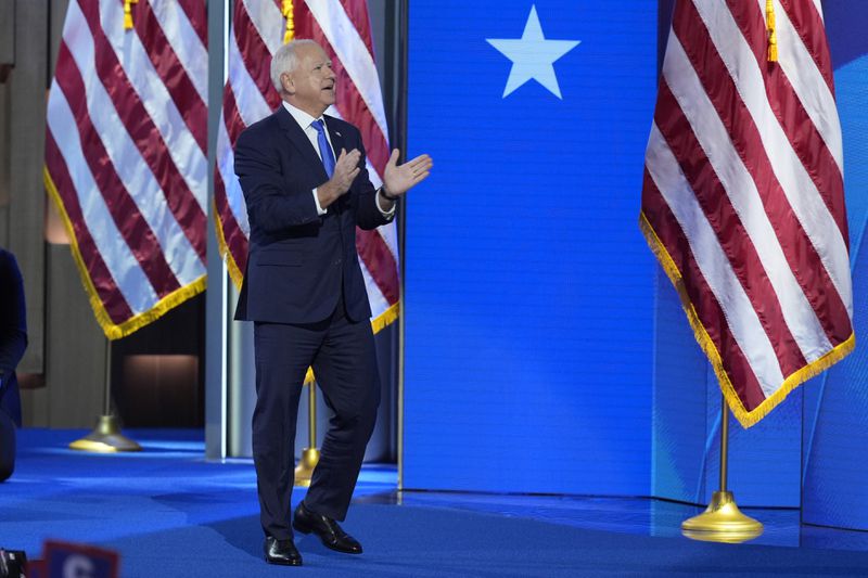 Democratic vice presidential nominee Minnesota Gov. Tim Walz walks on stage to speak during the Democratic National Convention Wednesday, Aug. 21, 2024, in Chicago. (AP Photo/J. Scott Applewhite)