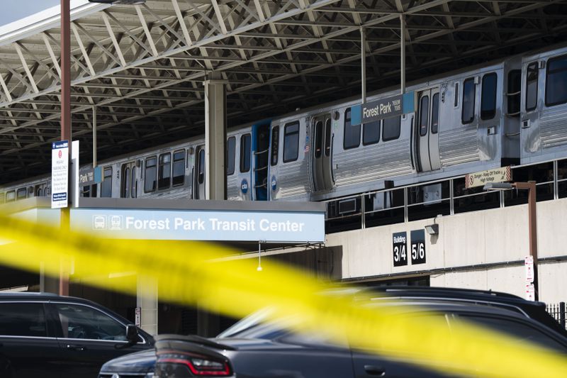 Yellow tape blocks off the parking lot of the Forest Park Blue Line train station in Forest Park, Ill., after four people were fatally shot on the train early Monday, Sept. 2, 2024. (Pat Nabong/Chicago Sun-Times via AP)