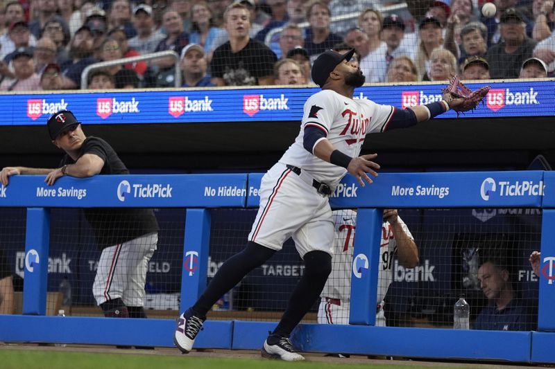 Minnesota Twins first baseman Carlos Santana catches a foul out by Atlanta Braves' Matt Olson during the fourth inning of a baseball game, Tuesday, Aug. 27, 2024, in Minneapolis. (AP Photo/Abbie Parr)