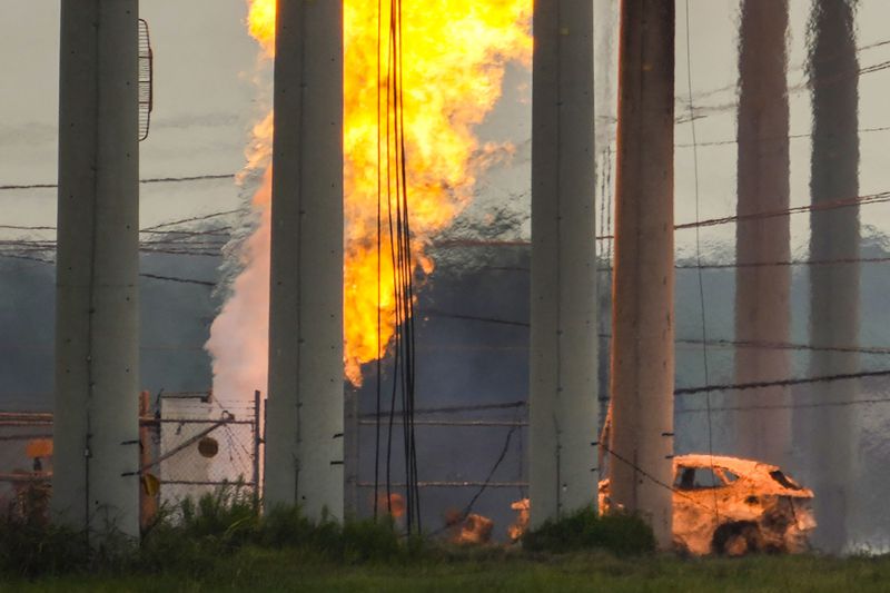 A massive pipeline fire burns after a vehicle drove through a fence along a parking lot and struck an above-ground valve near Spencer Highway and Summerton on Monday, Sept. 16, 2024, in La Porte, Texas. (Brett Coomer/Houston Chronicle via AP)