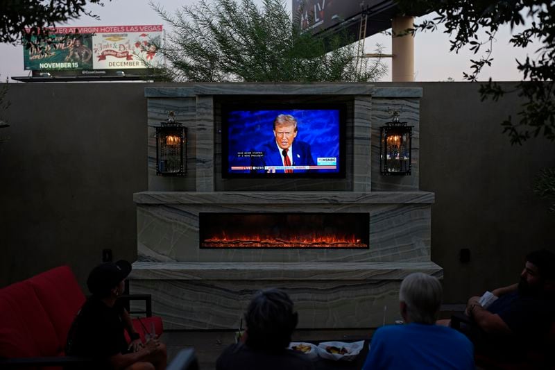 People watch the presidential debate between Republican presidential nominee former President Donald Trump and Democratic presidential nominee Vice President Kamala Harris, Tuesday, Sept. 10, 2024, at the Gipsy Las Vegas in Las Vegas. (AP Photo/John Locher)