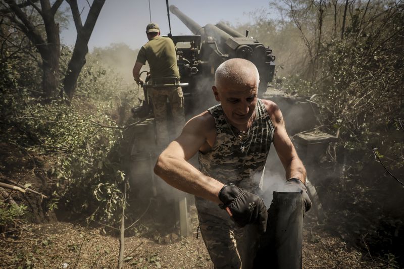 In this photo provided by Ukraine's 24th Mechanised Brigade press service, servicemen of the 24th Mechanised Brigade fire a" Giatsint-S" 152mm self-propelled howitzer towards Russian positions near Chasiv Yar town, in Donetsk region, Ukraine, Tuesday, Aug. 20, 2024. (Oleg Petrasiuk/Ukrainian 24th Mechanised Brigade via AP)