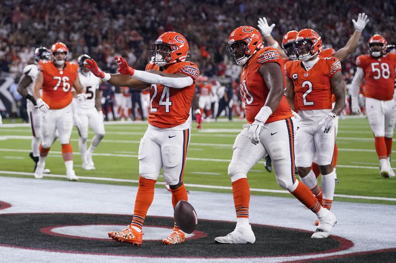 Chicago Bears running back Khalil Herbert (24) celebrates after scoring during the first half of an NFL football game against the Houston Texans Sunday, Sept. 15, 2024, in Houston. (AP Photo/Eric Christian Smith)