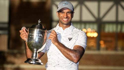 Aaron Rai, of England, poses with the trophy after winning the Wyndham Championship golf tournament in Greensboro, N.C., Sunday, Aug. 11, 2024. (AP Photo/Chuck Burton)