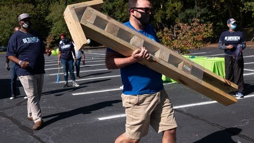 Brendon Briggs, who works in talent acquisition for Cox Enterprises, drops off an insect house he built for use in an outdoor learning lab at Harper-Archer Elementary School in Atlanta on Tuesday, Oct. 13, 2020. Ben Gray for the Atlanta Journal-Constitution