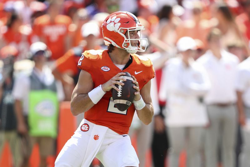 Clemson quarterback Cade Klubnik (2) drops back to pass during the first half of an NCAA college football game against North Carolina State Saturday, Sept. 21, 2024, in Clemson, S.C. (AP Photo/Artie Walker Jr.)