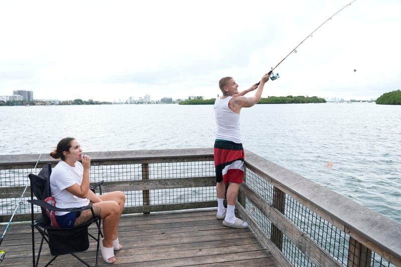 Tristan Martin and his girlfriend Lilly Ortega of Miami, go fishing on their day off at Oleta River State Park, Thursday, Aug. 22, 2024, in North Miami Beach, Fla. (AP Photo/Marta Lavandier)