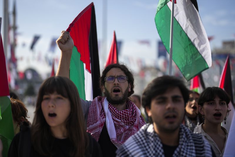 Demonstrators hold Palestinian flags and chant slogans during a pro Palestinian protest in Istanbul, Turkey, Saturday, Oct. 5, 2024. (AP Photo/Khalil Hamra)