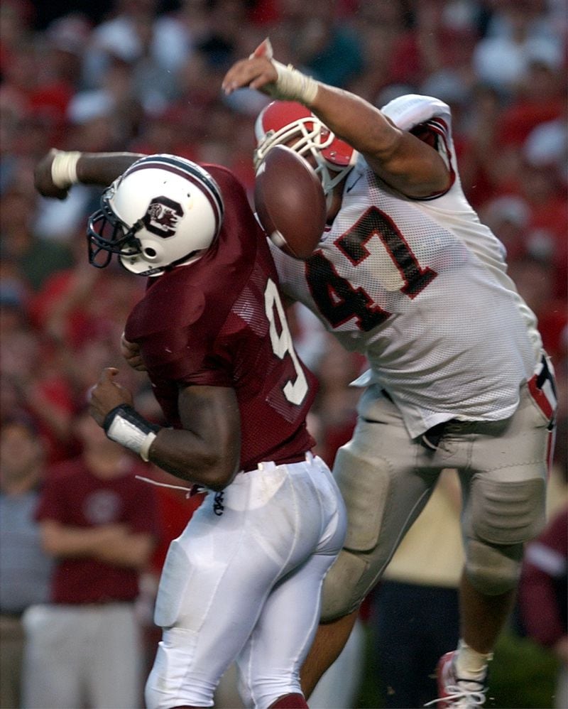 Take a look at photos of Georgia players making big hits, solid tackles and athletic interceptions -- in the past. Players like Bill Stanfill, Richard Tardits, David Pollack, Thomas Davis and Boss Bailey made big plays in some of the best seasons in UGA history. Bulldogs fans are expecting a return to glory with Jeremy Pruitt coaching the defense after a couple of seasons of disappointing defensive efforts.In this photo, UGA's David Pollack strips the ball from South Carolina quarterback Corey Jenkins in 2002 in the end zone and scores a memorable touchdown.