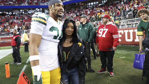 FILE - Then-Green Bay Packers' Jonathan Owens (34) and Simone Biles pose for a photo before an NFL football NFC divisional playoff game against the San Francisco 49ers, Jan. 20, 2024, in Santa Clara, Calif. Chicago Bears safety Owens has arranged to take leave from training camp and is heading to Paris, Monday, July 29, 2024, to watch his wife Biles compete for the U.S. gymnastics team. (AP Photo/Jed Jacobsohn, File)