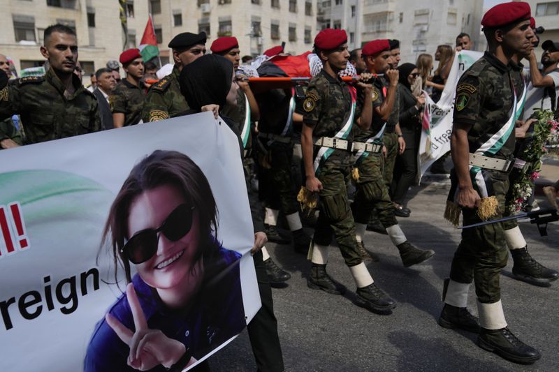 A Palestinian honor guard carries the body of Aysenur Ezgi Eygi, 26, who was fatally shot by Israeli soldiers while participating in an anti-settlement protest in the West Bank, during her funeral procession in the West Bank city of Nablus, Monday, Sept. 9, 2024. (AP Photo/Nasser Nasser)