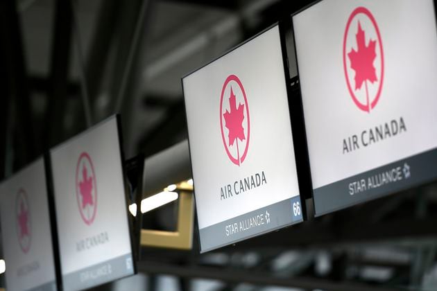 FILE - Air Canada check-in screens are seen at the Ottawa International Airport in Ottawa, Ontario, May 16, 2020. (Justin Tang/The Canadian Press via AP, File)