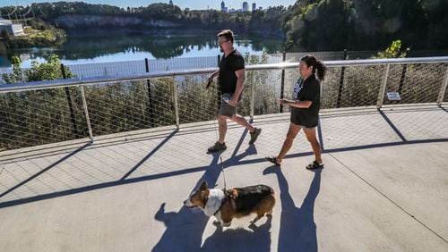 Joel and Vi Bouy walk their dog Yoshi at Westside Reservoir Park in Atlanta in October. The park, the largest in the city, opened to the public in 2021. (John Spink / John.Spink@ajc.com)