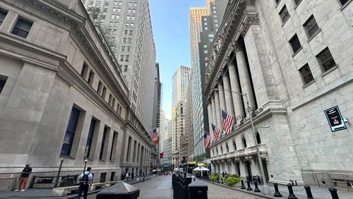 The New York Stock Exchange, at right, is shown on Wednesday, Aug. 14, 2024, in New York. (AP Photo/Peter Morgan)