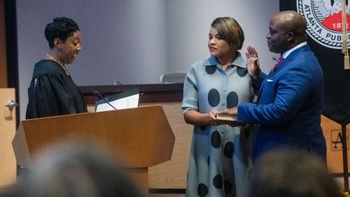 Atlanta Public Schools Superintendent Bryan Johnson puts his hand on a Bible during his swearing-in ceremony in Atlanta on Monday, Aug. 5, 2024.  (Ziyu Julian Zhu / AJC)