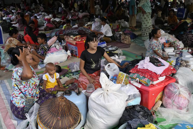 Flood victims take rest at temporary camp opened at monastery in Naypyitaw, Myanmar, Sunday, Sept. 15, 2024. (AP Photo/Aung Shine Oo)