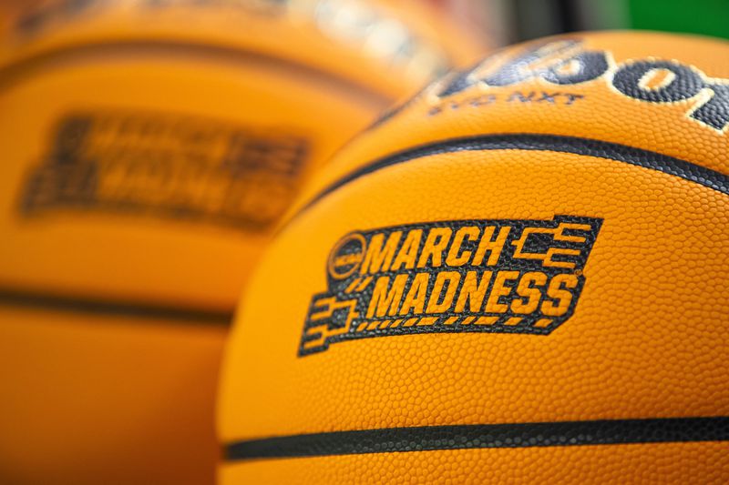 FILE - March Madness branding is displayed a Wilson EVO NXT basketball before a first-round college basketball game between Kent State and Notre Dame in the women's NCAA Tournament Saturday March 23, 2024, in South Bend, Ind. The NCAA has presented a plan to Division I conference commissioners that would expand the lucrative men's and women's basketball tournaments by four or eight teams alongside an option to leave each field at 68 teams, according to a person familiar with the details. (AP Photo/Michael Caterina, File)