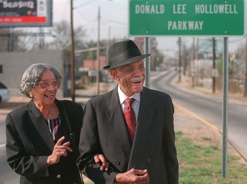 Louise Hollowell and her husband Donald Lee Hollowell standing at road sign " Donald Lee Hollowell Parkway" - Bankhead Highway has been renamed in his honor. Photo taken December 3, 1998. (CQ) (NICK ARROYO/AJC staff)