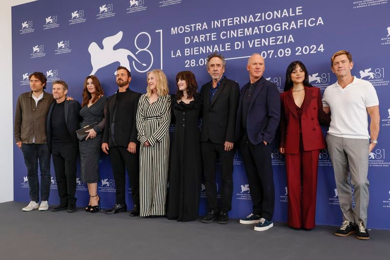 Producer Jeremy Kleiner, from left, Willem Dafoe, Monica Bellucci, Justin Theroux, Catherine O'Hara, Winona Ryder, director Tim Burton, Michael Keaton, Jenna Ortega and producer Tommy Harper pose for photographers at the photo call for the film 'Beetlejuice Beetlejuice' during the 81st edition of the Venice Film Festival in Venice, Italy, on Wednesday, Aug. 28, 2024. (Photo by Joel C Ryan/Invision/AP)