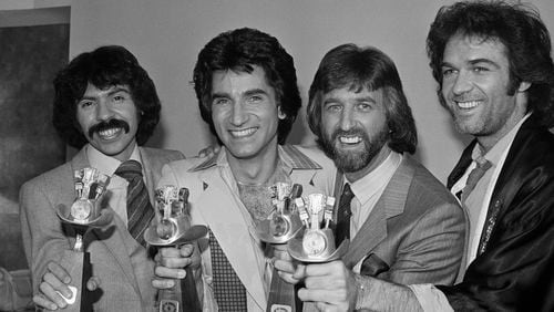 FILE - The Oak Ridge Boys, from left, Joe Bonsall, Richard Sterban, Duane Allen and William Lee Golden hold their awards for Top Vocal Group and Best Album of the Year for "Ya'll Come Back Saloon", during the 14th Annual Academy of Country Music Awards in Los Angeles, Calif., May 3, 1979. Bonsall died on Tuesday, July 9, 2024, from complications of Amyotrophic Lateral Sclerosis in Hendersonville, Tenn. He was 76. (AP Photo/Lennox Mclendon, File)