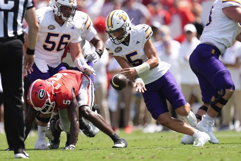 Tennessee Tech quarterback Jordyn Potts (5) looses his grip on the ball as Georgia linebacker Raylen Wilson (5) defends during the first half of an NCAA college football game Saturday, Sept. 7, 2024, in Athens, ga. (AP Photo/John Bazemore)