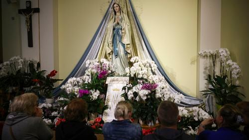 Pilgrims recited their prayers next to the statue of the Virgin Mary inside the St. James Church in Medjugorje, Bosnia, Thursday, Sept. 19, 2024. (AP Photo/Armin Durgut)