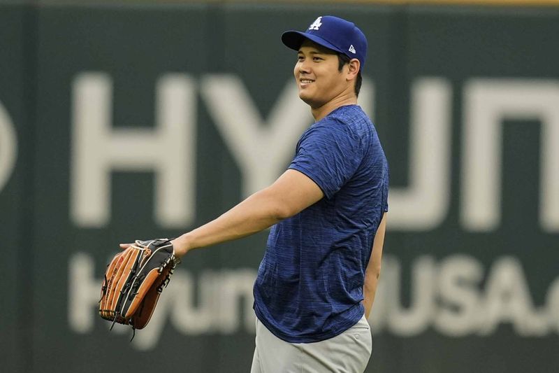 Los Angeles Dodgers' Shohei Ohtani warms up before a baseball game between the Atlanta Braves and the Los Angeles Dodgers, Friday, Sept. 13, 2024, in Atlanta. (AP Photo/Mike Stewart)