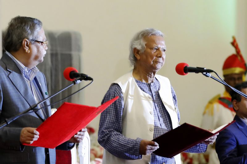 FILE - Bangladesh's figurehead President Mohammed Shahabuddin administers the oath of office to Nobel laureate Muhammad Yunus, right, as the head of Bangladesh's interim government, in Dhaka, Bangladesh, on Aug. 8, 2024. (AP Photo/Rajib Dhar, File)