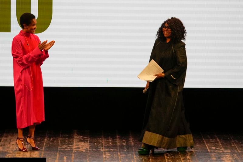 Afro Fashion Association founder Michelle Ngonmo is helmed by Host Tamu McPherson during the second edition of the 'Black carpet awards' in Milan, Italy, Friday, Sept. 20, 2024. (AP Photo/Luca Bruno).