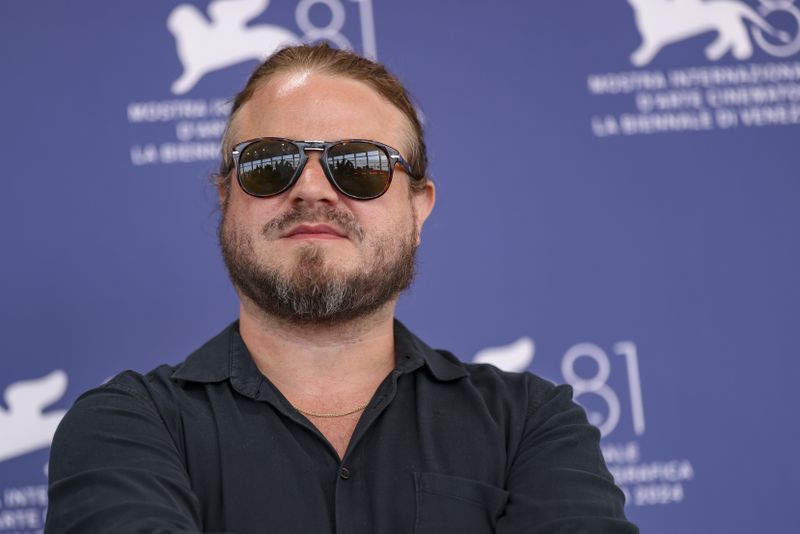 Director Brady Corbet poses for photographers at the photo call for the film 'The Brutalist' during the 81st edition of the Venice Film Festival in Venice, Italy, on Sunday, Sept. 1, 2024. (Photo by Vianney Le Caer/Invision/AP)