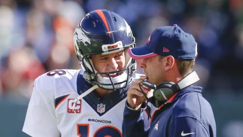 ADVANCE FOR WEEKEND EDITIONS, DEC. 20-21- FILE - In this Oct. 12, 2014, file photo, Denver Broncos quarterback Peyton Manning (18) talks with offensive coordinator Adam Gase between plays during the third quarter of an NFL football game against the New York Jets in East Rutherford, N.J. The Associated Press will honor an NFL assistant coach for the first time this year with his own award. (AP Photo/Kathy Willens, File) Denver Broncos quarterback Peyton Manning (18) talks with offensive coordinator Adam Gase between plays during the third quarter of an NFL football game against the New York Jets in East Rutherford, N.J. He was interview by the Falcons on Friday. (AP Photo/Kathy Willens, File)