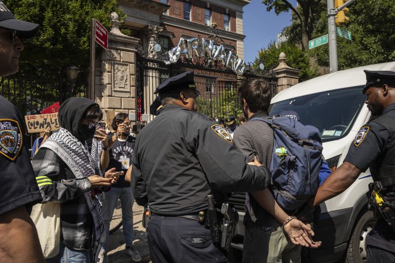 NYPD officers detain a pro-Palestinian supporter as they hold picket line outside Barnard College, Tuesday, Sept. 3, 2024, in New York. (AP Photo/Yuki Iwamura)