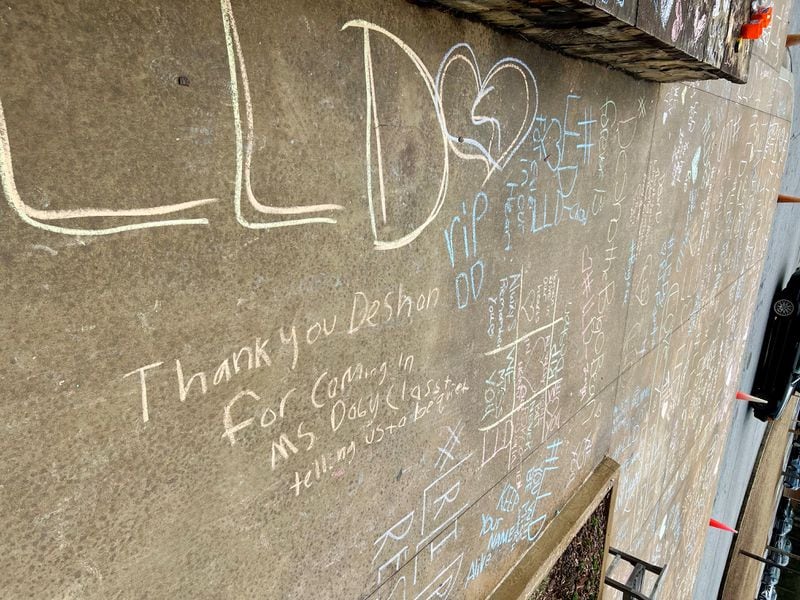 Messages for Deshon DuBose were written in chalk in front of Drew Charter School.