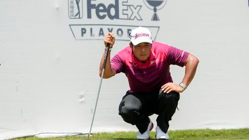 Hideki Matsuyama, of Japan, lines up his putt on the 17th green during the second round of the St. Jude Championship golf tournament Friday, Aug. 16, 2024, in Memphis, Tenn. (AP Photo/Mark Humphrey)