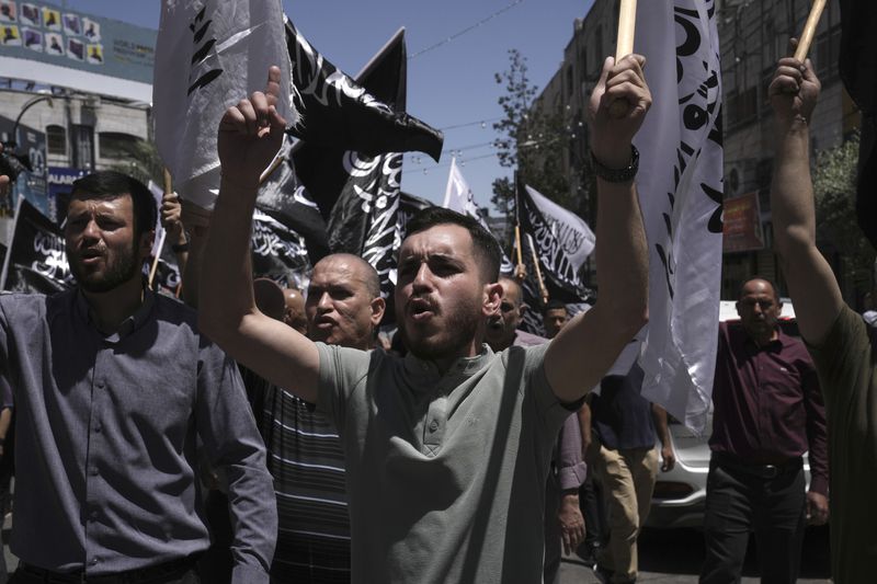 Hundreds of Palestinians march to call on Arab states to intervene to save the Gaza Strip, in a protest organized by the Hizb ut-Tahrir party in the West Bank city of Ramallah, Friday, May 24, 2024. The march came as a response to the ongoing Israeli war in the Gaza Strip, which has caused significant civilian casualties. (AP Photo/Mahmoud Illean)