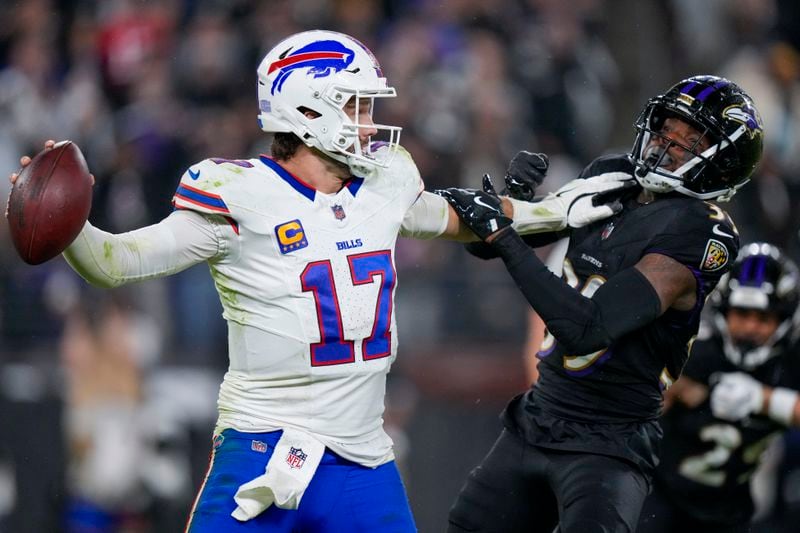 Buffalo Bills quarterback Josh Allen tries to fend off Baltimore Ravens safety Eddie Jackson during the second half of an NFL football game, Sunday, Sept. 29, 2024, in Baltimore. (AP Photo/Stephanie Scarbrough)