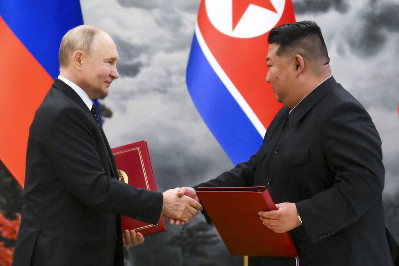 Russian President Vladimir Putin, left, and North Korea's leader Kim Jong Un shake hands after a signing ceremony of the new partnership in Pyongyang, North Korea, on Wednesday, June 19, 2024. Putin and North Korean leader Kim Jong Un signed a new partnership that includes a vow of mutual aid if either country is attacked, during a Wednesday summit that came as both face escalating standoffs with the West. (Kristina Kormilitsyna, Sputnik, Kremlin Pool Photo via AP)