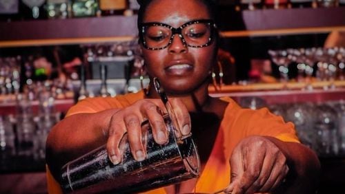 Kia Palmer shaking up cocktails using Black owned spirits at Jo Jo's beloved Cocktail Lounge. /
Courtesy of Nate Refell