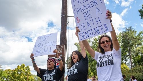 Incarcerated Lives Matter protesters, including Jenny Arellano, from left, Aubri Escalera and Dr. Christy Perez, right, call for reform of the Georgia prison system with a gathering across the street from the Governor's Mansion on Tuesday. That day, the U.S. Department of Justice released a damning report on violent conditions within the state's prison system. (Jenni Girtman for The Atlanta Journal-Constitution)