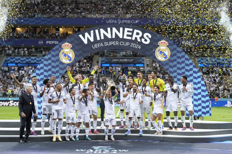 Real Madrid's Luka Modric lifts the trophy after winning the UEFA Super Cup Final soccer match between Real Madrid and Atalanta at the Narodowy stadium in Warsaw, Poland, Wednesday, Aug. 14, 2024. Real Madrid won 2-0. (AP Photo/Darko Bandic)