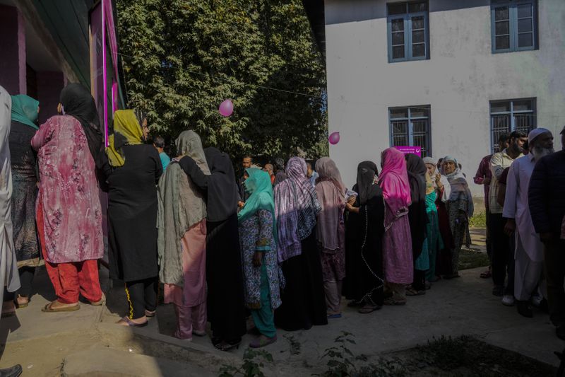 Kashmiris queue up at a polling booth to cast their vote during the final phase of an election to choose a local government in Indian-controlled Kashmir, north of Srinagar, Tuesday, Oct.1, 2024. (AP Photo/Mukhtar Khan)