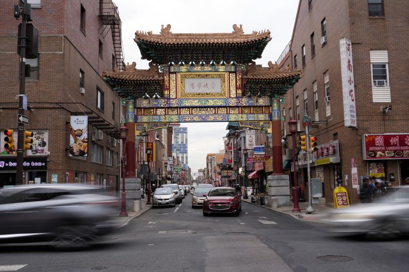 Evening traffic passes near the Chinatown neighborhood of Philadelphia, Wednesday, Sept. 18, 2024. (AP Photo/Matt Slocum)